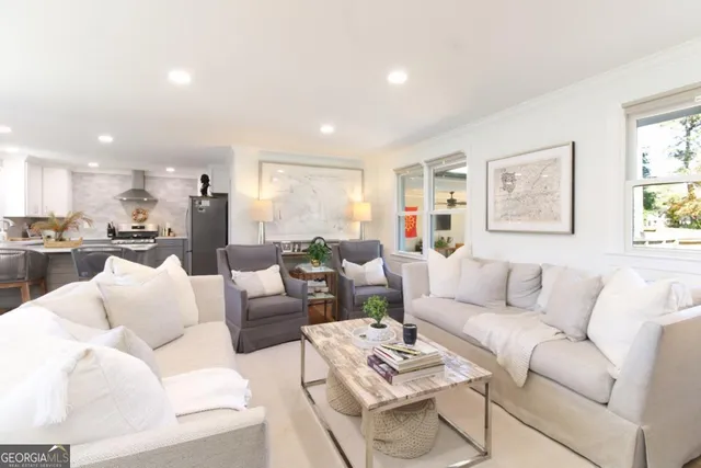 a living room with furniture kitchen and a table