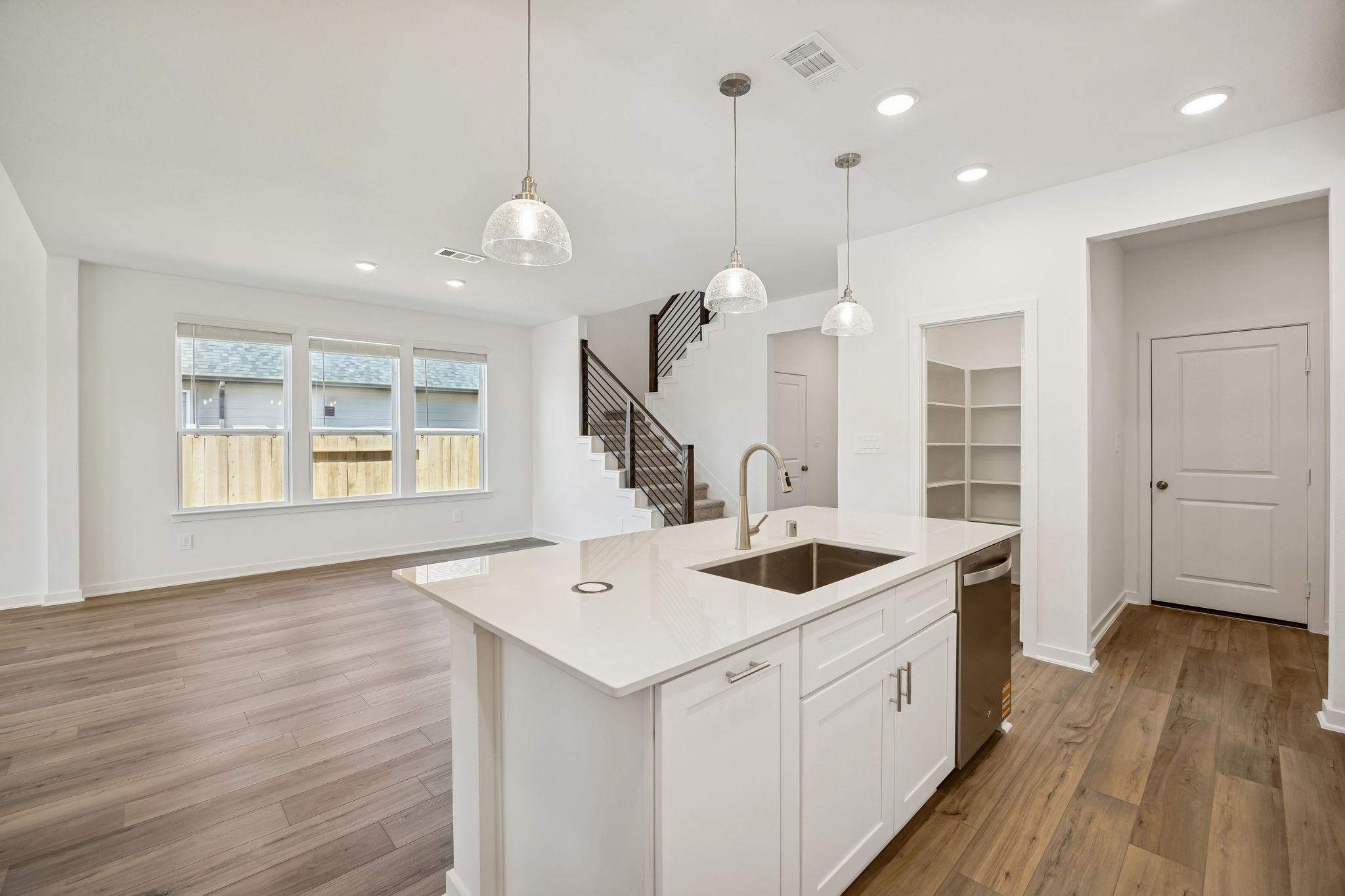 214 Pr Rdg Lane Montgomery, TX 77356 - Photo 4 of 35 a large kitchen with kitchen island a stove a sink a center island and wooden floor
