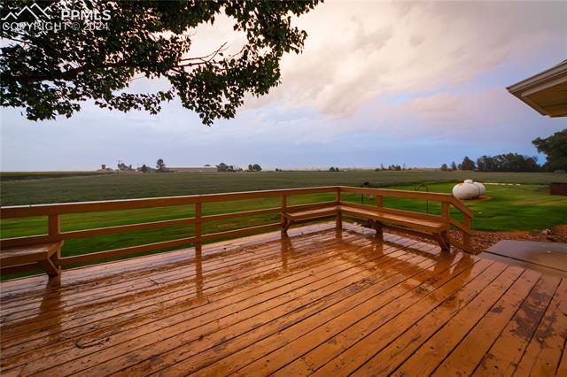 1027 County Road LL Fowler, CO 81039 - Photo 32 of 37 Wooden terrace with a rural view