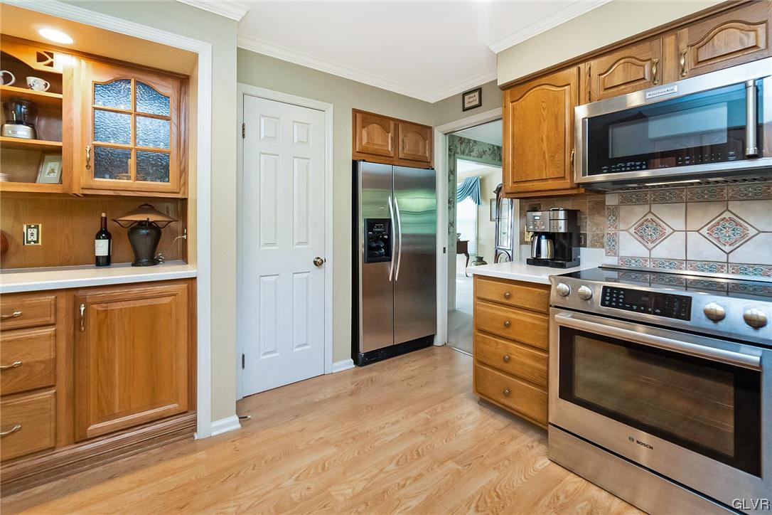 2285 Woodbarn Road Lower Macungie Township, PA 18062 - Photo 13 of 45 a kitchen with stainless steel appliances granite countertop a stove and a microwave oven
