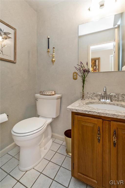 2285 Woodbarn Road Lower Macungie Township, PA 18062 - Photo 20 of 45 a bathroom with a granite countertop toilet a sink and a mirror