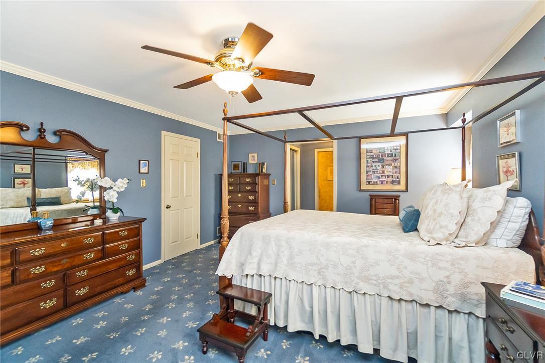 2285 Woodbarn Road Lower Macungie Township, PA 18062 - Photo 21 of 45 a bedroom with a bed and a chandelier