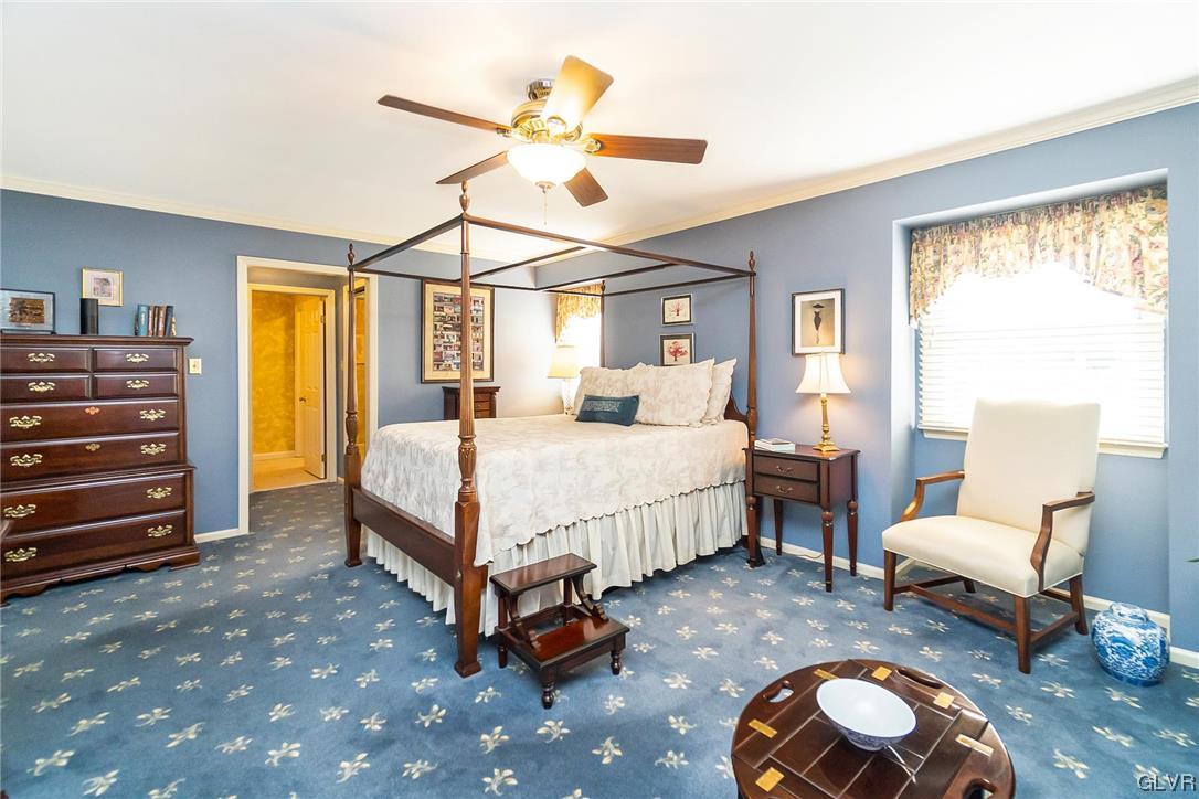 2285 Woodbarn Road Lower Macungie Township, PA 18062 - Photo 22 of 45 a bedroom with a bed a chandelier and a dresser