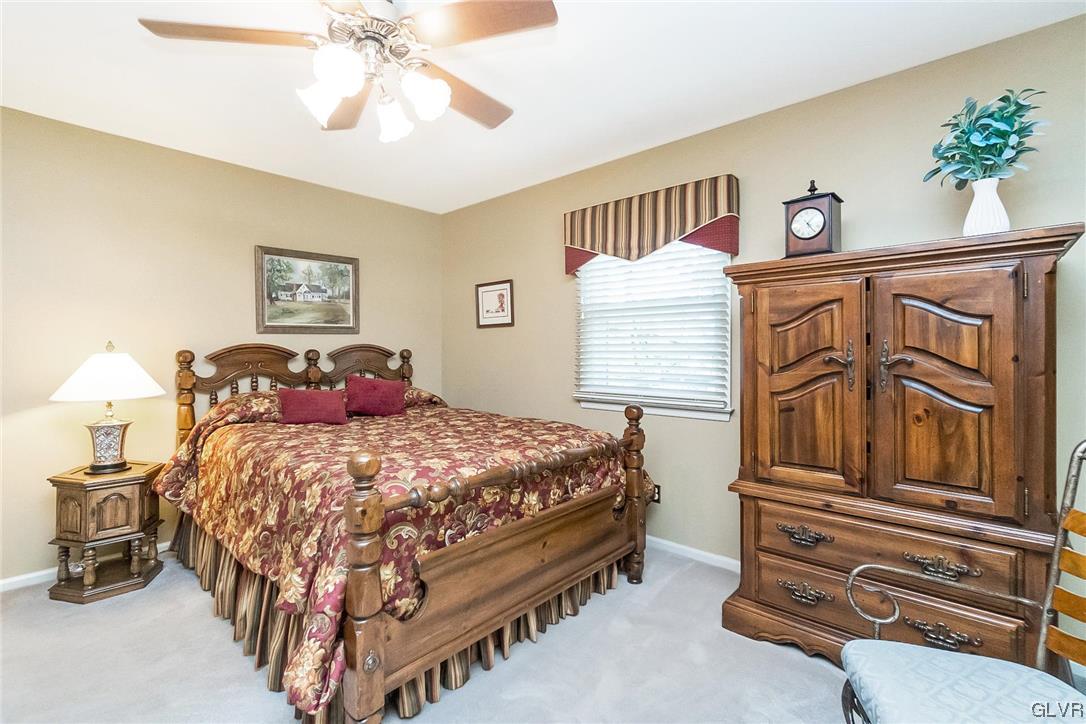 2285 Woodbarn Road Lower Macungie Township, PA 18062 - Photo 30 of 45 a bedroom with a bed and a chandelier