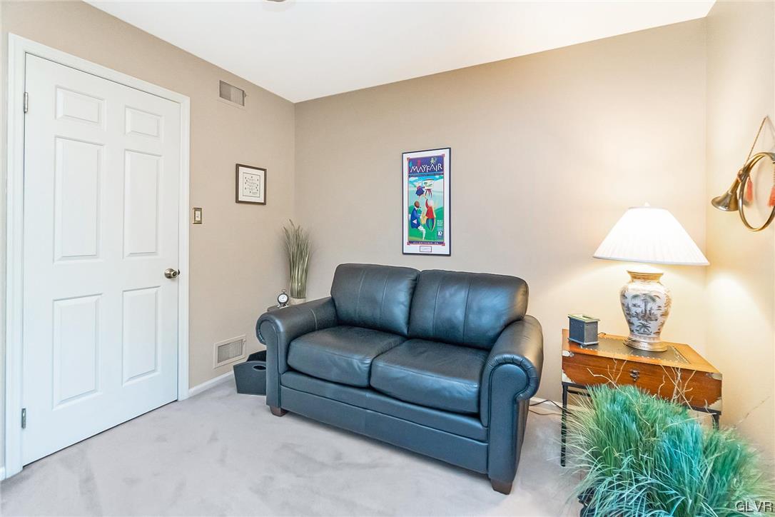 2285 Woodbarn Road Lower Macungie Township, PA 18062 - Photo 32 of 45 a living room with furniture and a lamp
