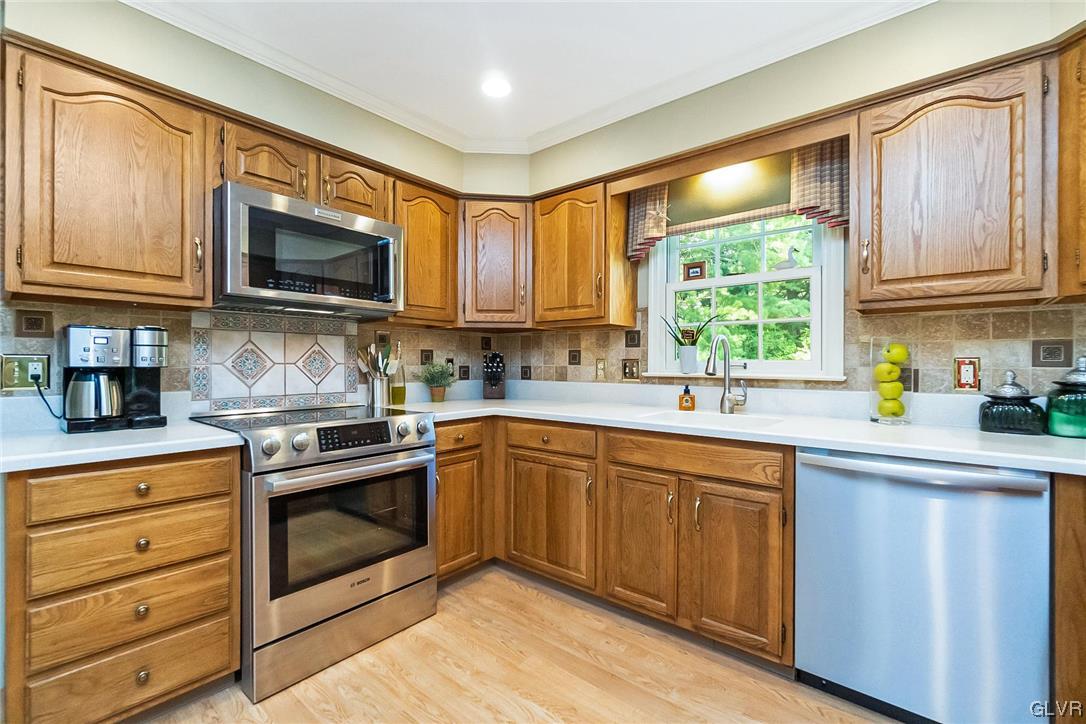 2285 Woodbarn Road Lower Macungie Township, PA 18062 - Photo 10 of 45 a kitchen with stainless steel appliances granite countertop wooden cabinets a sink and a window