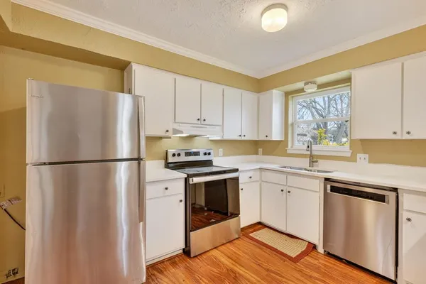 a kitchen with a refrigerator sink and cabinets