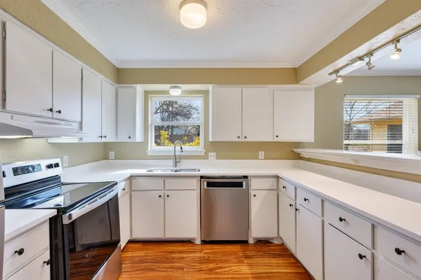 a kitchen with a sink stove and cabinets