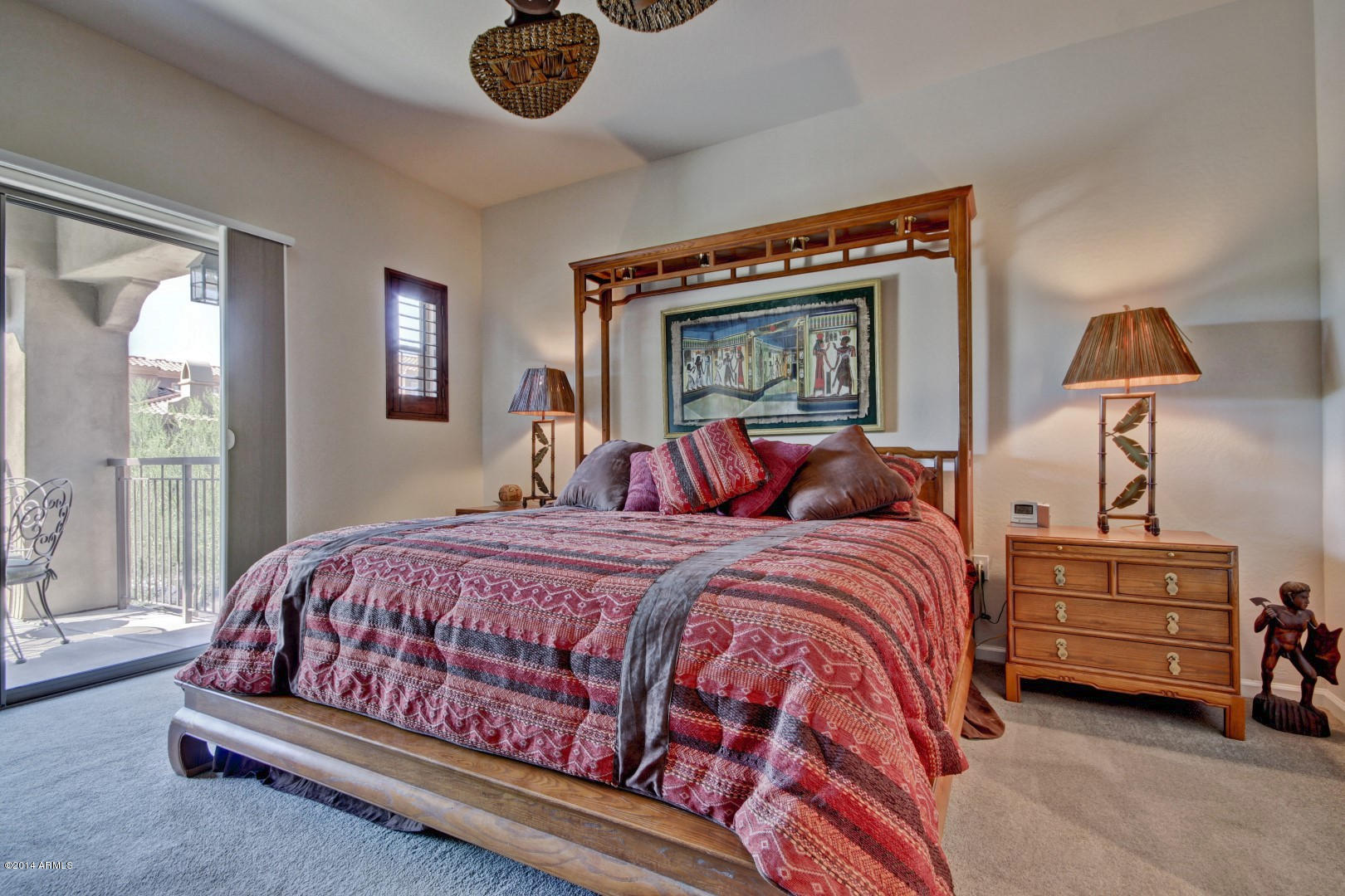 3935 East Rough Rider Road, Unit 1089 Phoenix, AZ 85050 - Photo 26 of 71 a bed room with a bed and a lamp
