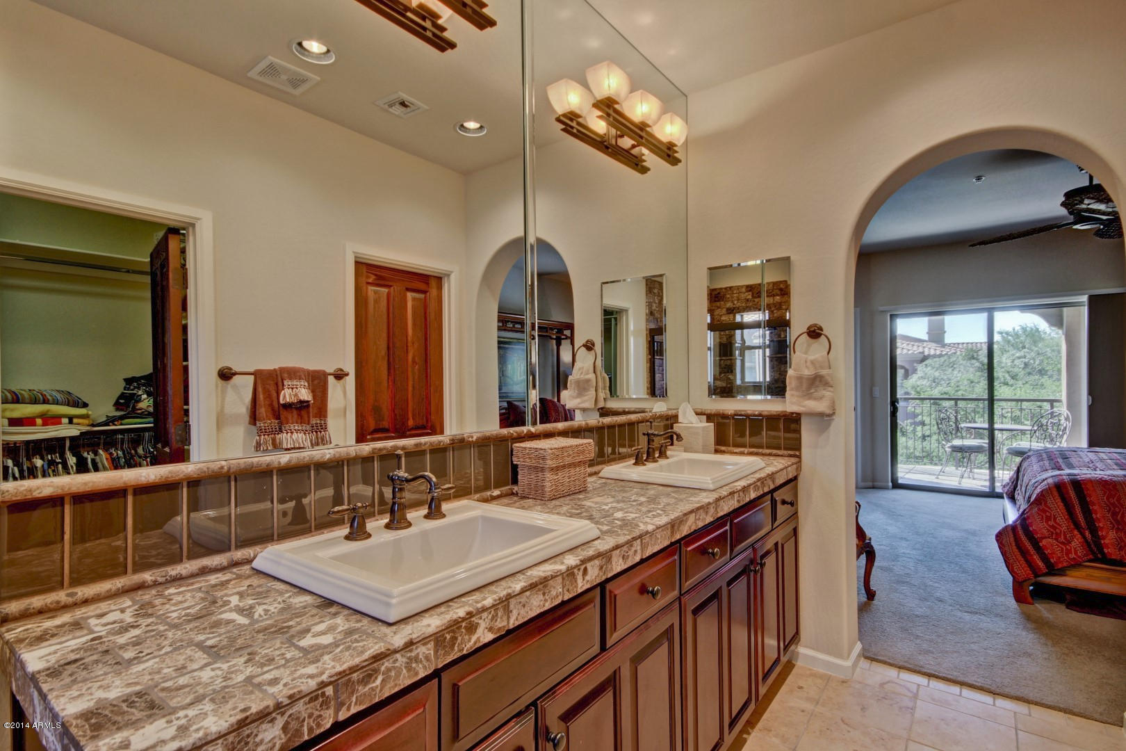 3935 East Rough Rider Road, Unit 1089 Phoenix, AZ 85050 - Photo 29 of 71 a spacious bathroom with a granite countertop sink and a mirror