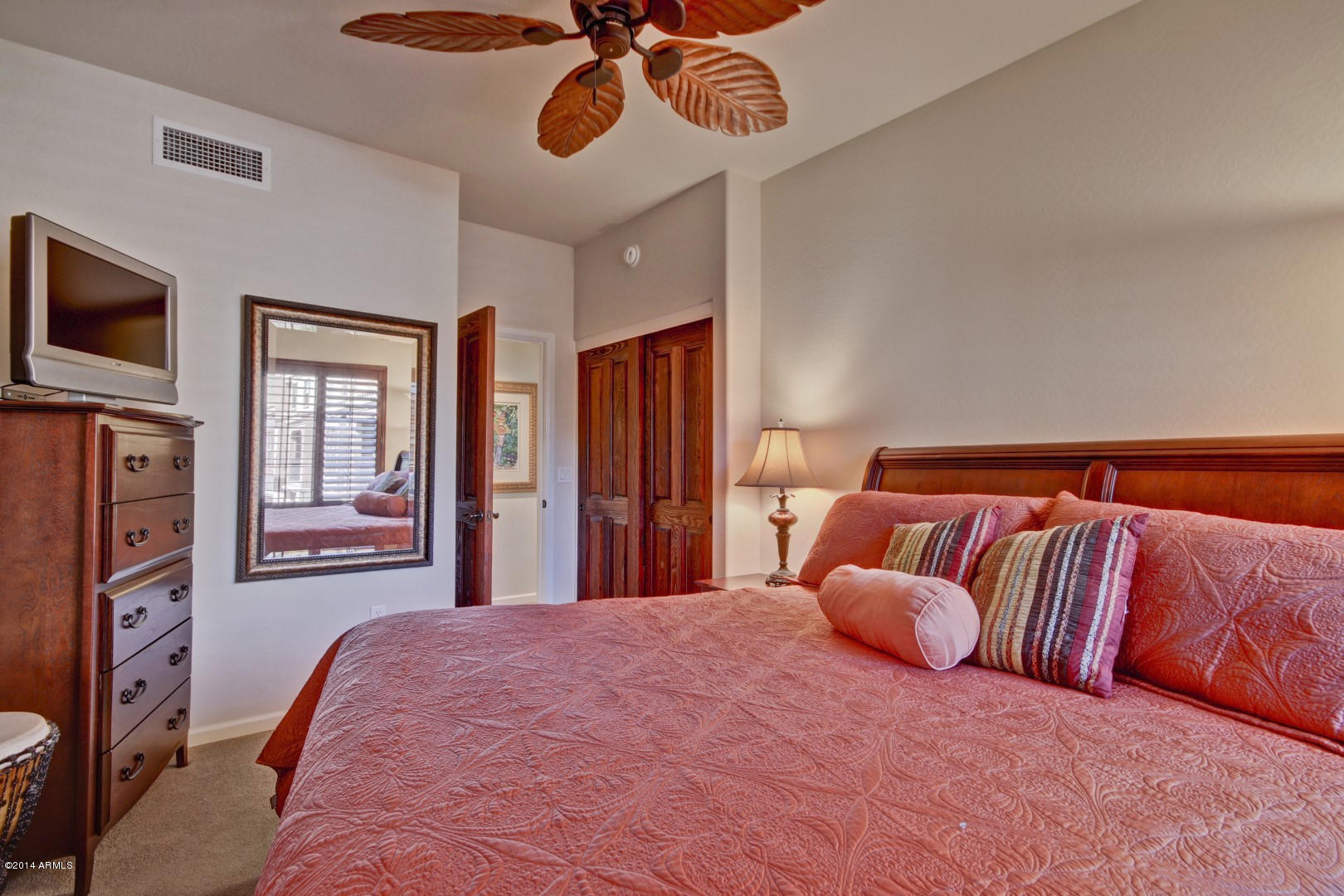 3935 East Rough Rider Road, Unit 1089 Phoenix, AZ 85050 - Photo 33 of 71 a bedroom with a large bed and flat tv screen