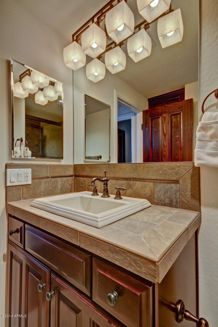 3935 East Rough Rider Road, Unit 1089 Phoenix, AZ 85050 - Photo 36 of 71 a bathroom with a sink and a mirror