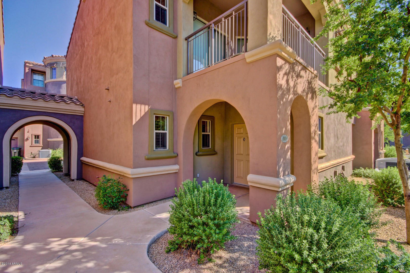 3935 East Rough Rider Road, Unit 1089 Phoenix, AZ 85050 - Photo 44 of 71 a front view of a house with garden