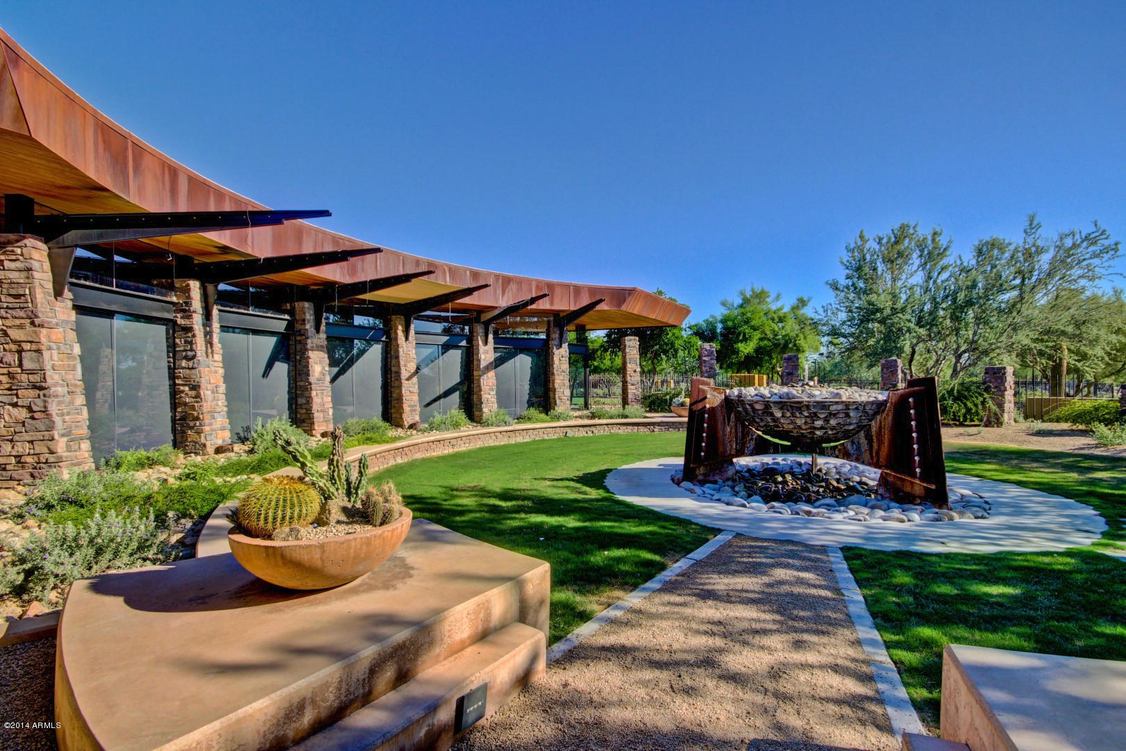 3935 East Rough Rider Road, Unit 1089 Phoenix, AZ 85050 - Photo 57 of 71 a front view of a house with garden