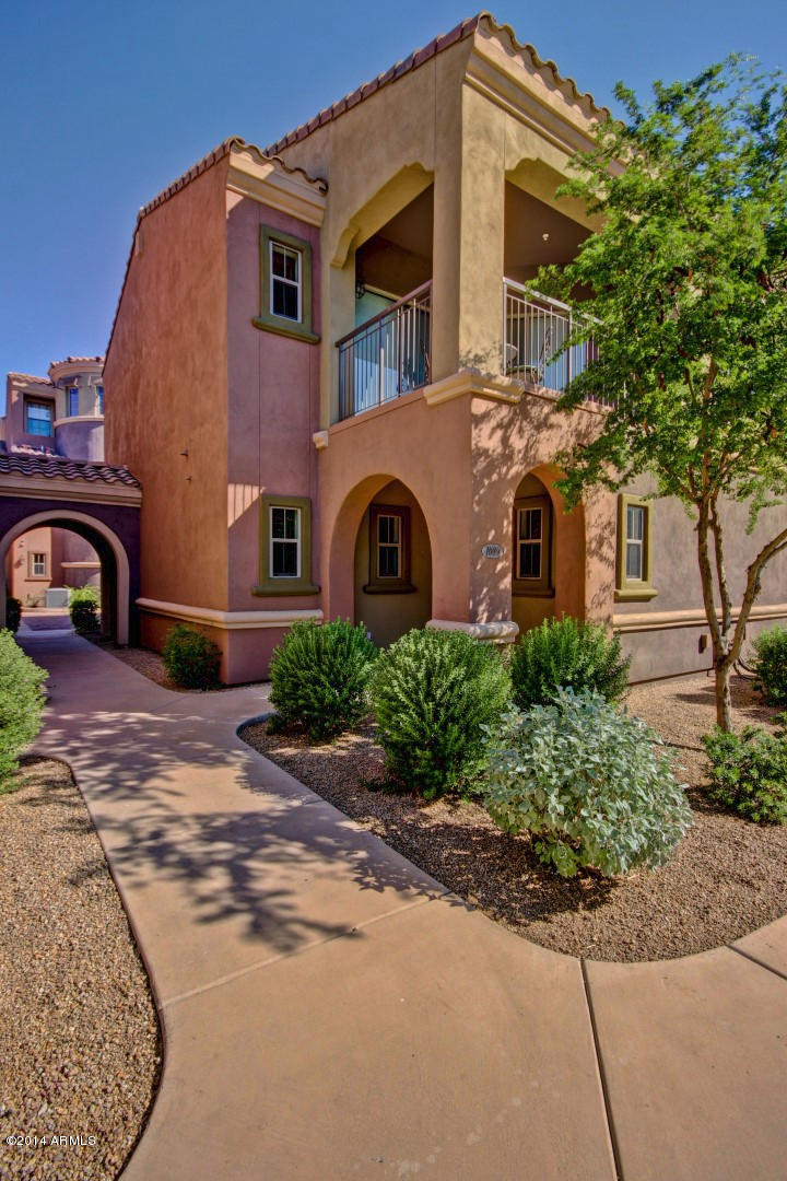 3935 East Rough Rider Road, Unit 1089 Phoenix, AZ 85050 - Photo 6 of 71 a front view of a house with garden