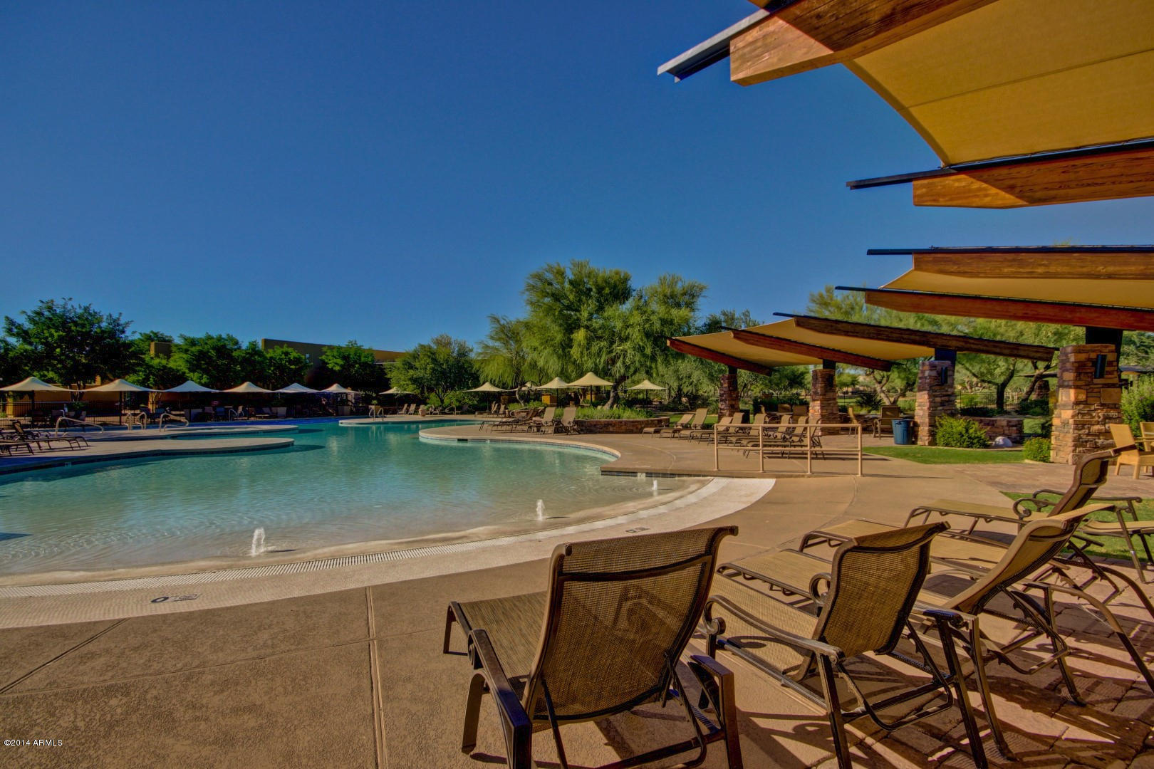 3935 East Rough Rider Road, Unit 1089 Phoenix, AZ 85050 - Photo 65 of 71 a view of a swimming pool with outdoor seating and plants