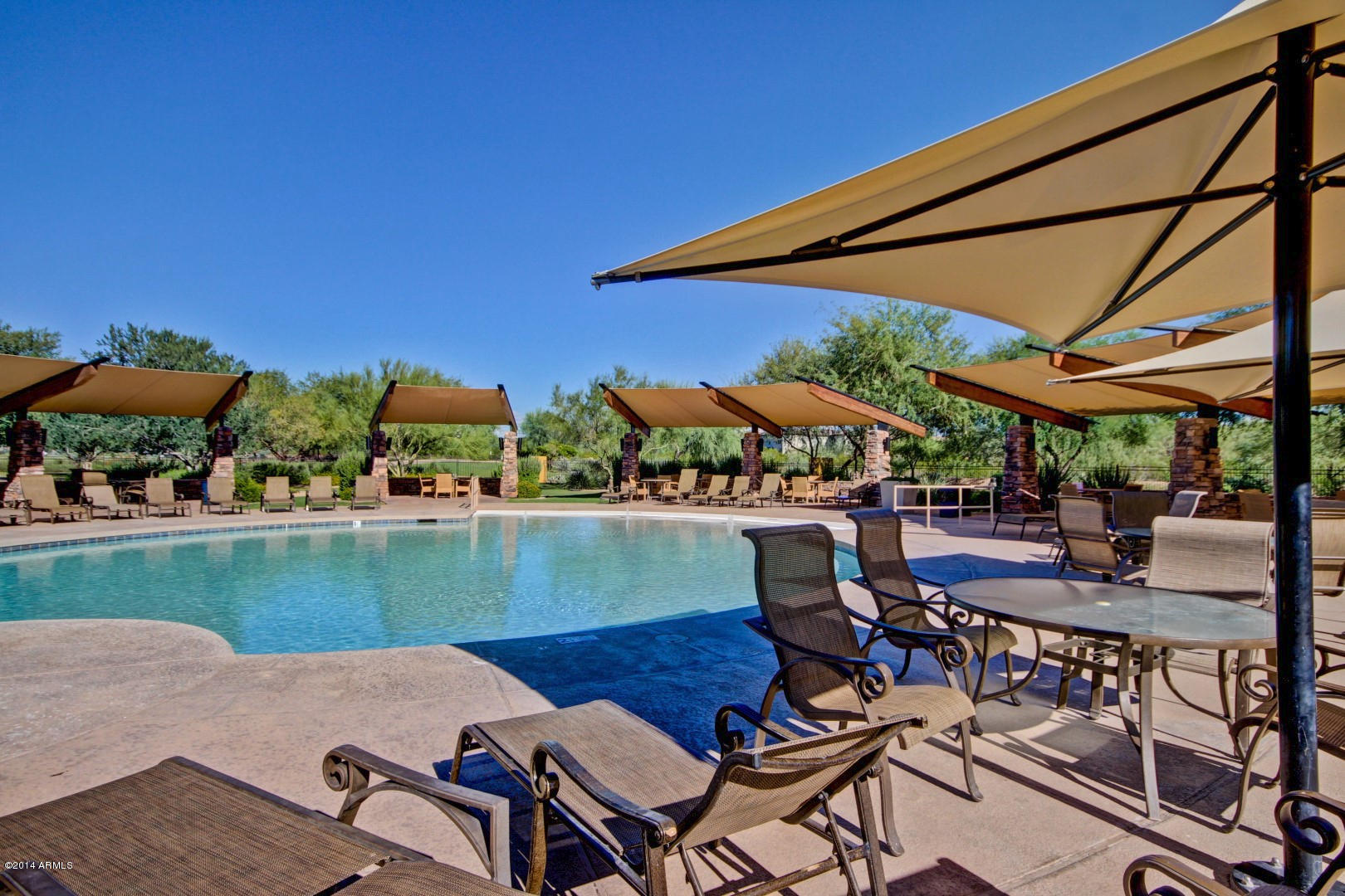 3935 East Rough Rider Road, Unit 1089 Phoenix, AZ 85050 - Photo 67 of 71 an outdoor space with furniture and umbrella