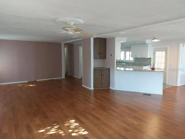 a view of a kitchen with wooden floor and a kitchen