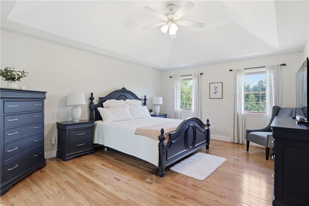 2057 Stirnie Road Victor, NY 14564 - Photo 23 of 48 The primary bedroom features crisp wall finishes, warm carpeting, and a wide window that frames peaceful views of the surrounding countryside.