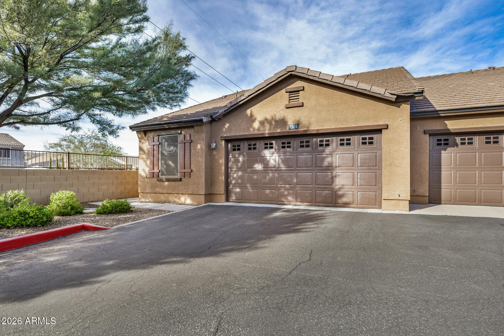 2725 East Mine Creek Road, Unit 1101 Phoenix, AZ 85024 - Photo 5 of 43 a front view of a house with a yard and garage