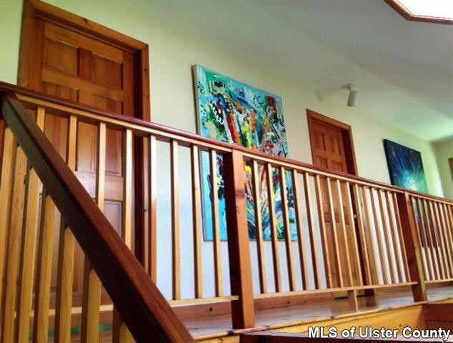 219 Cherry Hill Road Accord, NY 12404 - Photo 7 of 15 a view of staircase with lots of frames on wall and a large window