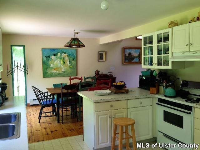 219 Cherry Hill Road Accord, NY 12404 - Photo 8 of 15 a dining room with furniture a window and stainless steel appliances