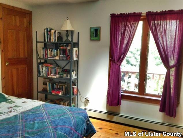 219 Cherry Hill Road Accord, NY 12404 - Photo 10 of 15 a bedroom with a bed a bookshelf and a window