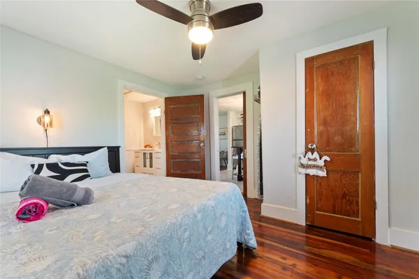 a bedroom with a bed and wooden floor