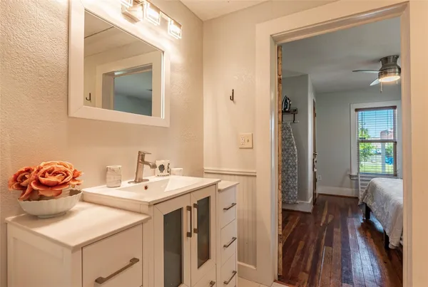 a bathroom with a sink vanity and a mirror