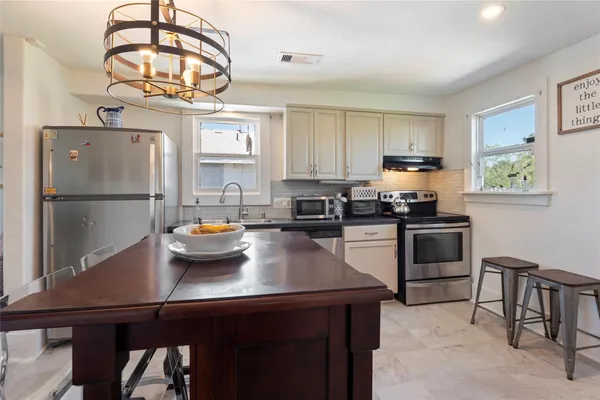 a kitchen with a sink appliances and cabinets
