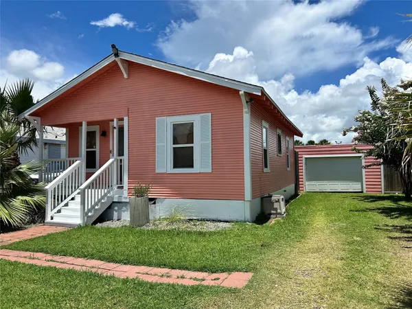 a front view of house with yard and garage