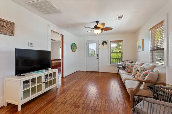 a view of a livingroom with furniture and a flat screen tv