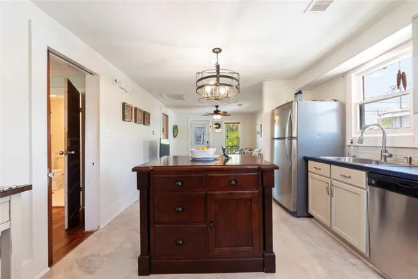 a kitchen with stainless steel appliances granite countertop a refrigerator and a sink
