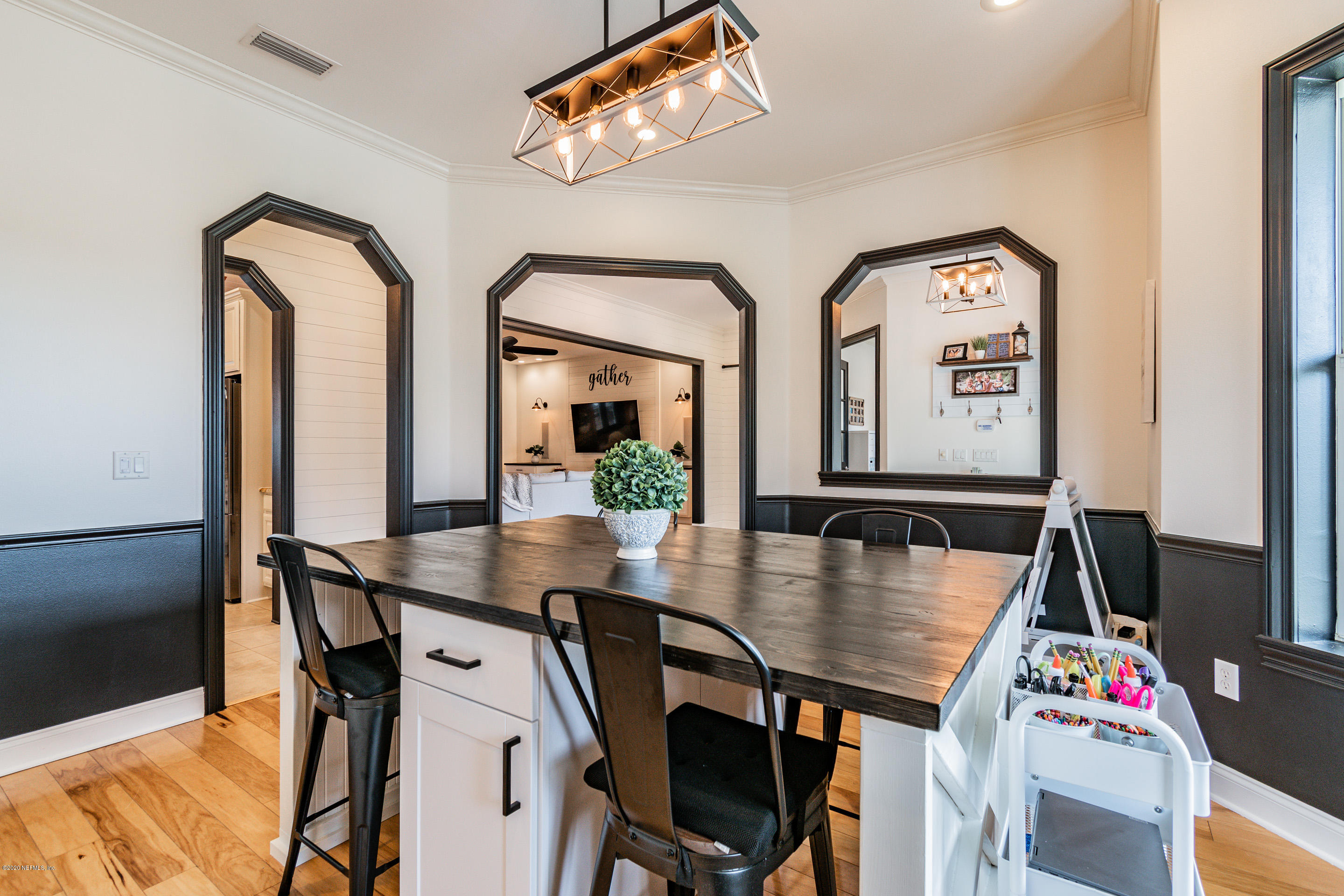 14689 Diamond Ranch Drive Jacksonville, FL 32234 - Photo 11 of 76 a view of a dining room with furniture and a chandelier