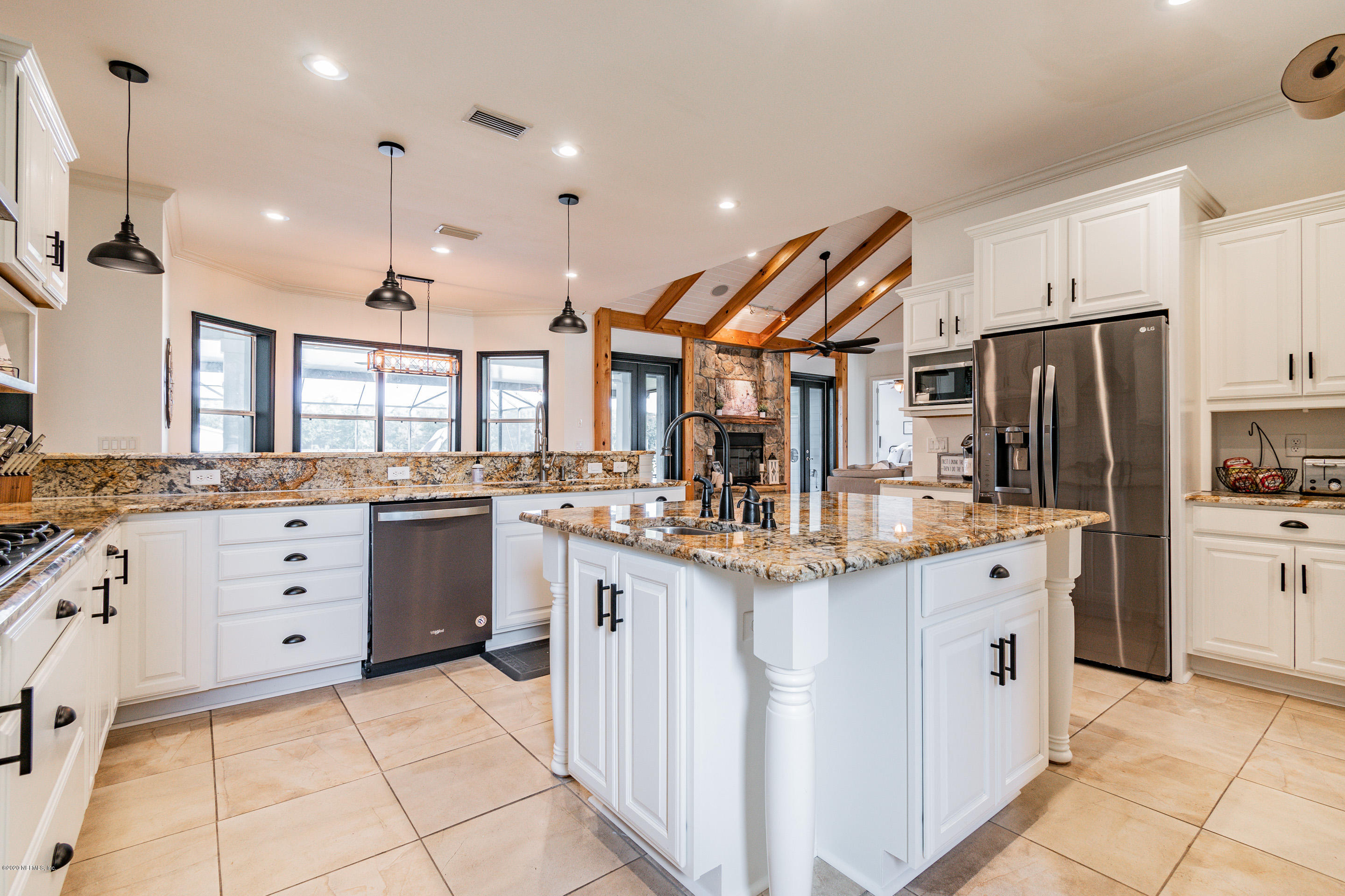 14689 Diamond Ranch Drive Jacksonville, FL 32234 - Photo 15 of 76 a kitchen with stainless steel appliances kitchen island granite countertop a sink and cabinets