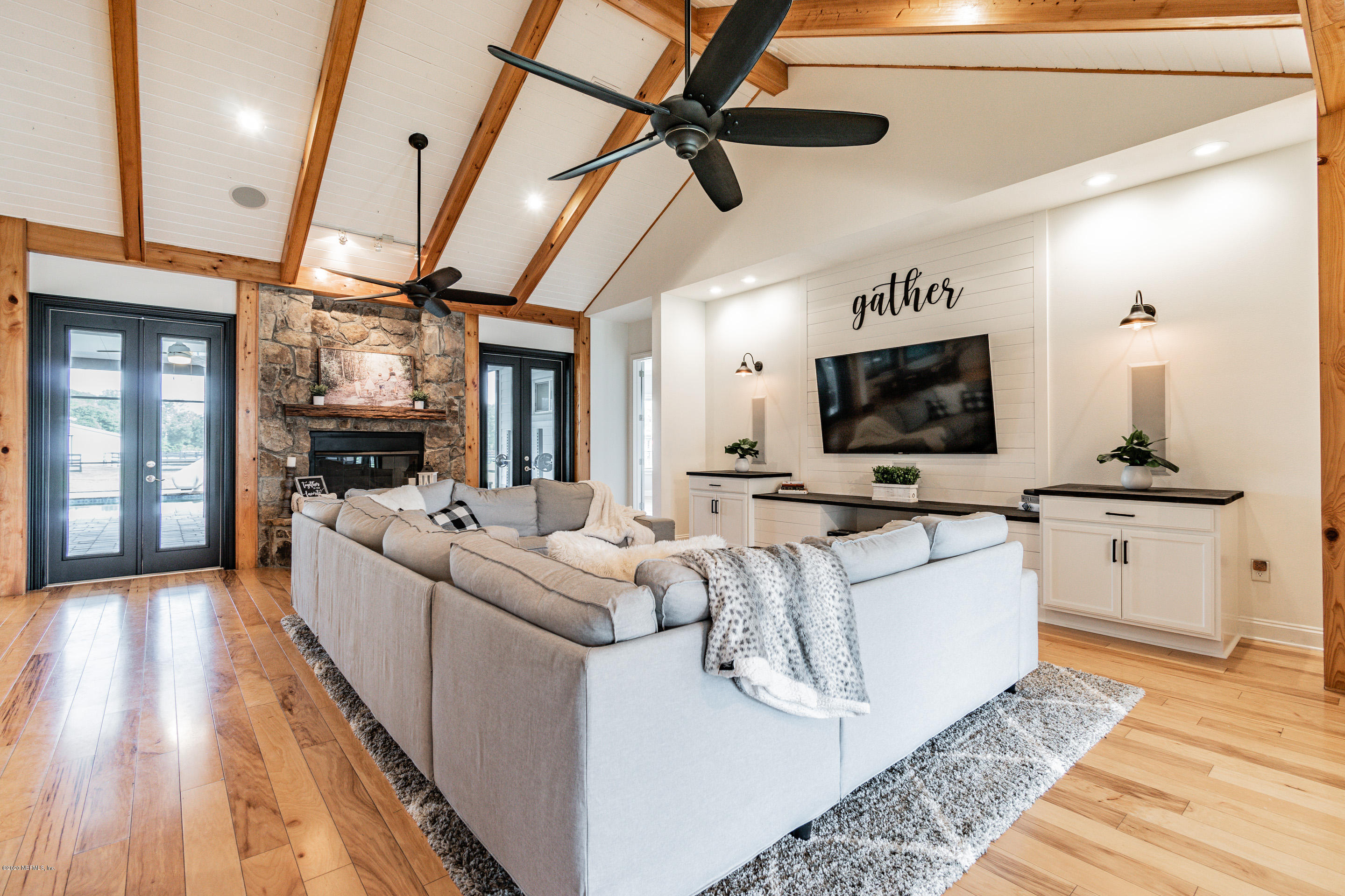 14689 Diamond Ranch Drive Jacksonville, FL 32234 - Photo 25 of 76 a living room with furniture and a flat screen tv