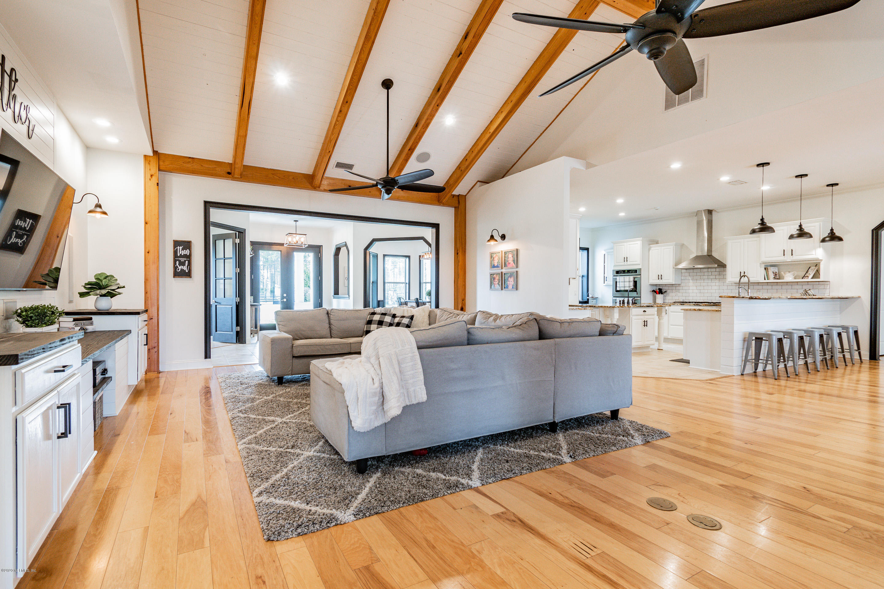 14689 Diamond Ranch Drive Jacksonville, FL 32234 - Photo 27 of 76 a living room with furniture and a flat screen tv