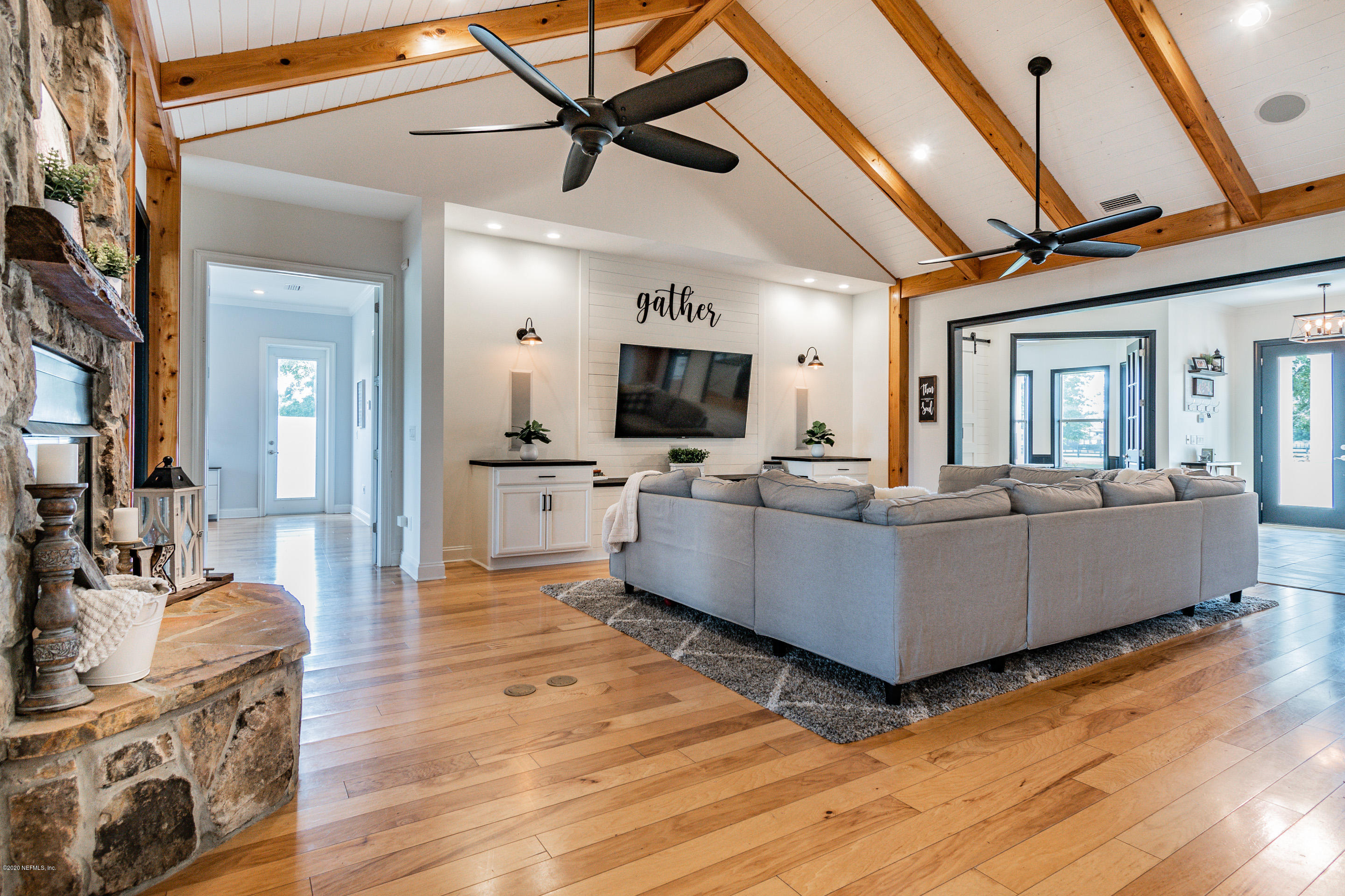 14689 Diamond Ranch Drive Jacksonville, FL 32234 - Photo 28 of 76 a living room with furniture wooden floor and a view of kitchen