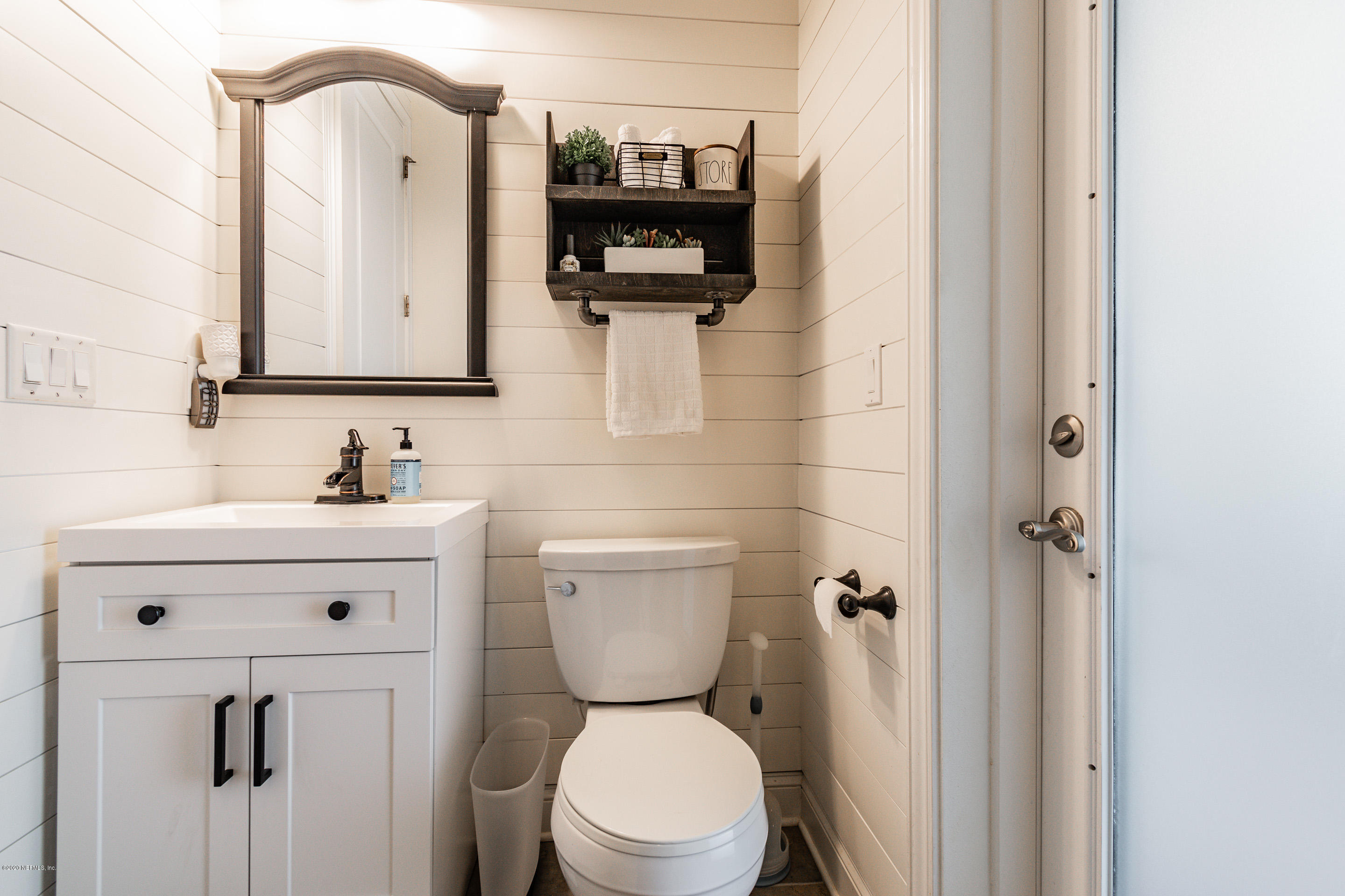 14689 Diamond Ranch Drive Jacksonville, FL 32234 - Photo 41 of 76 a bathroom with a sink a toilet and a mirror
