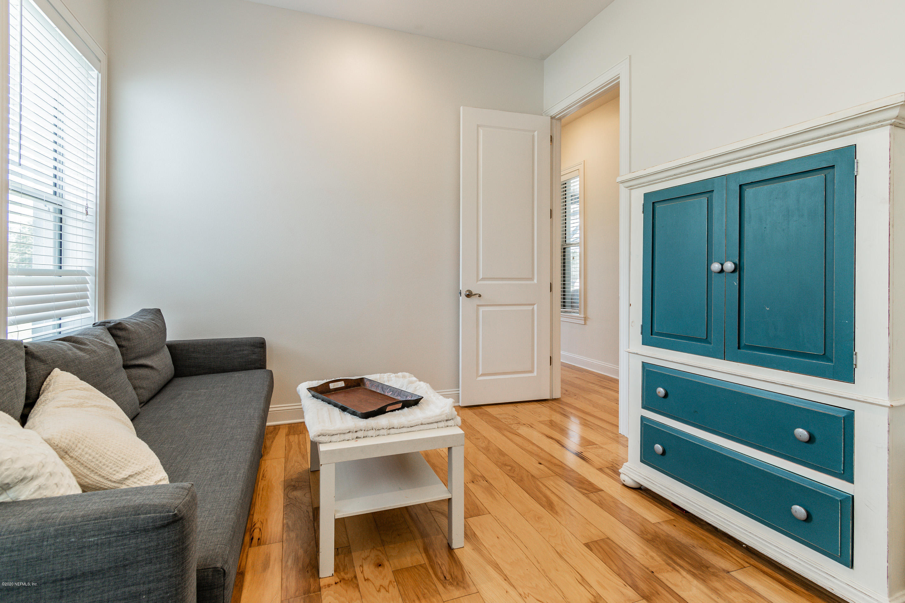 14689 Diamond Ranch Drive Jacksonville, FL 32234 - Photo 44 of 76 a living room with furniture and a wooden floor