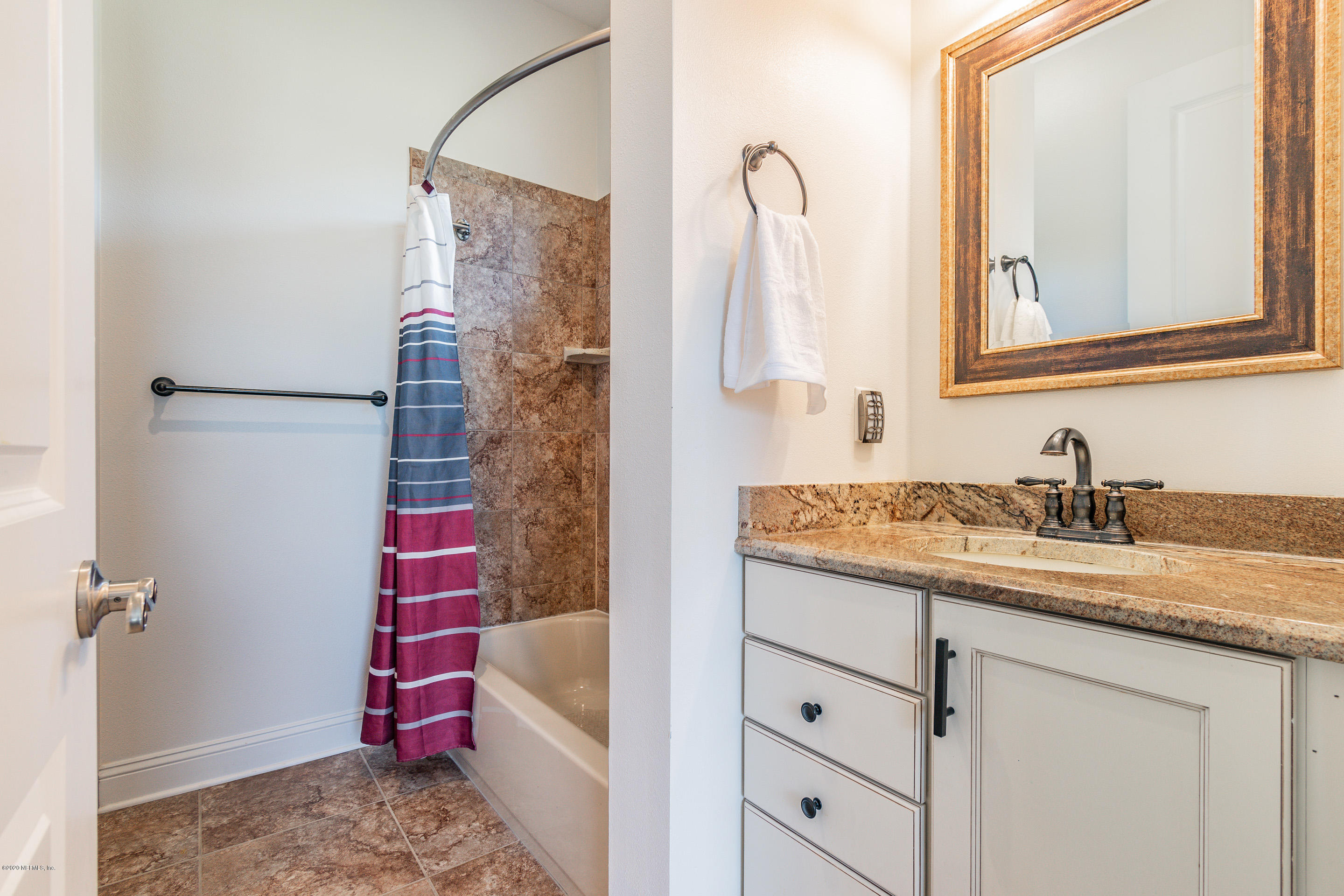 14689 Diamond Ranch Drive Jacksonville, FL 32234 - Photo 47 of 76 a bathroom with a granite countertop sink a toilet and a shower