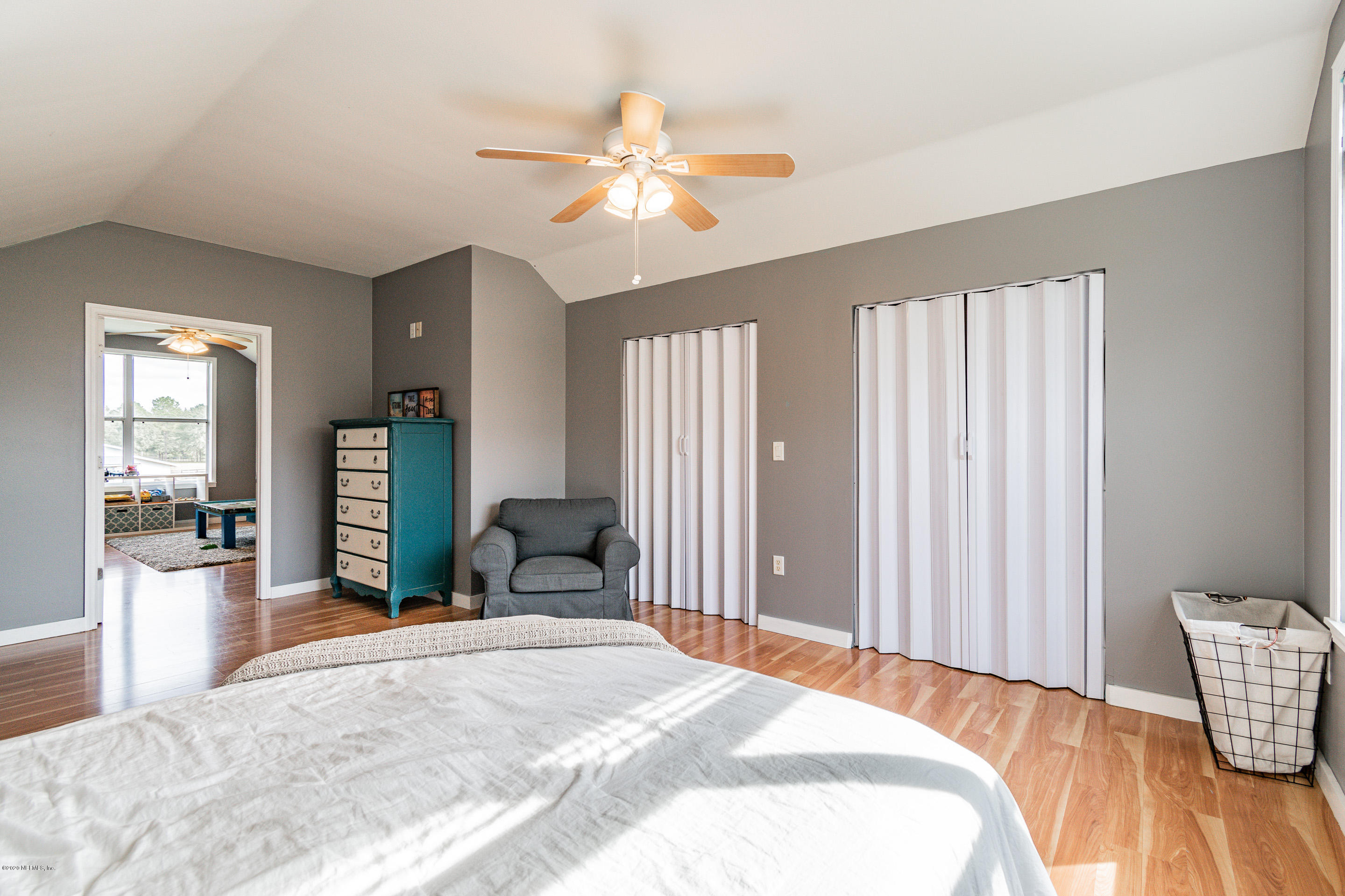 14689 Diamond Ranch Drive Jacksonville, FL 32234 - Photo 50 of 76 a bedroom with a bed and a large mirror