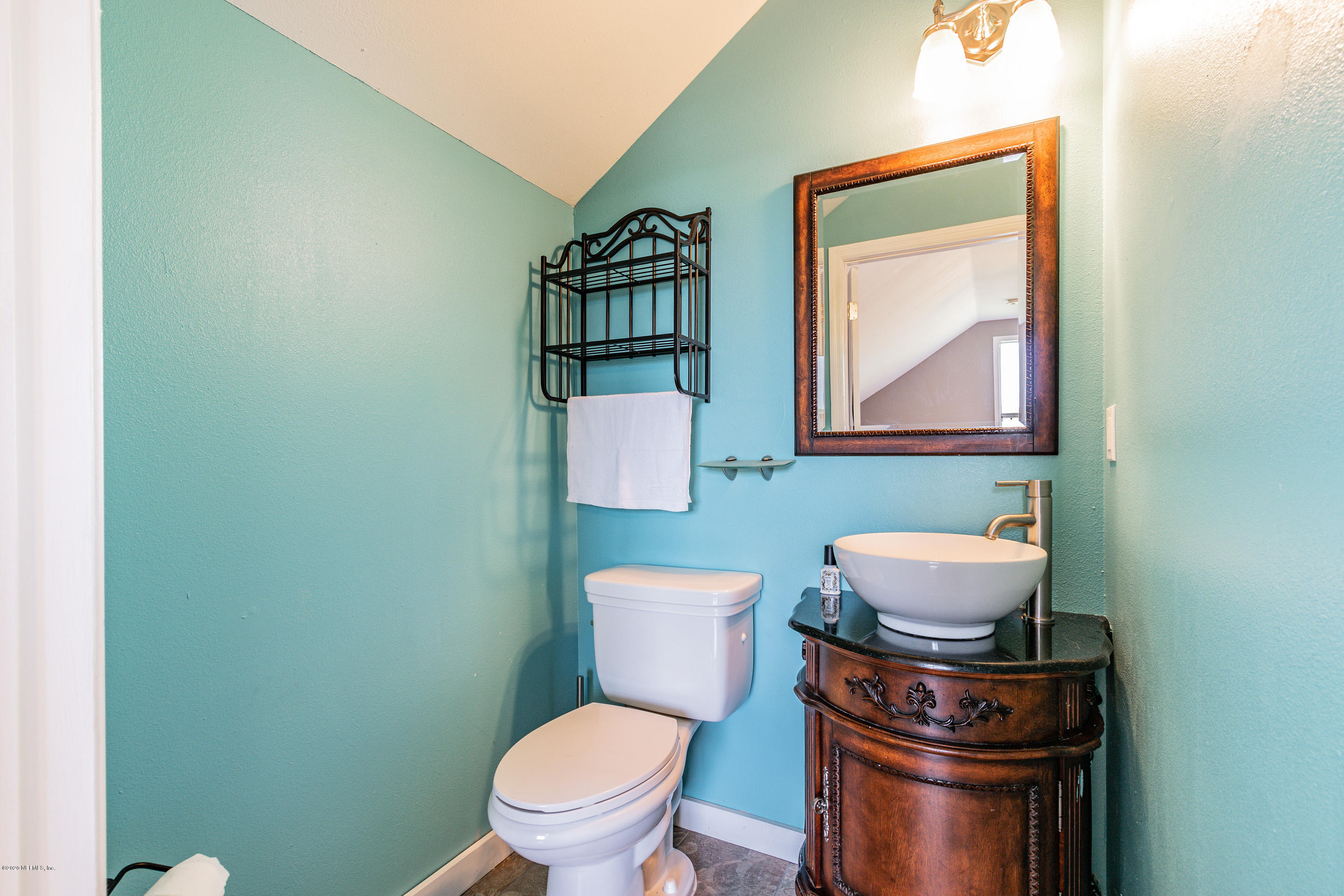 14689 Diamond Ranch Drive Jacksonville, FL 32234 - Photo 52 of 76 a bathroom with a toilet a sink and mirror