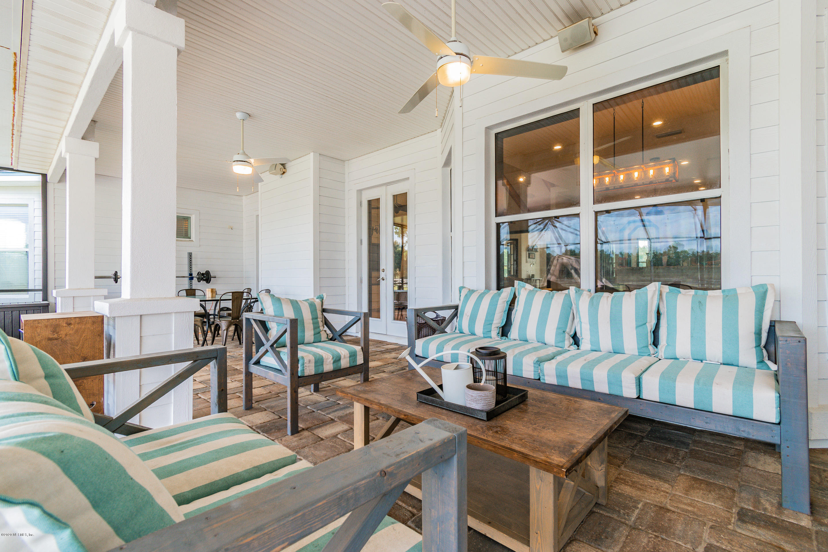 14689 Diamond Ranch Drive Jacksonville, FL 32234 - Photo 57 of 76 a view of a livingroom with furniture and floor to ceiling window