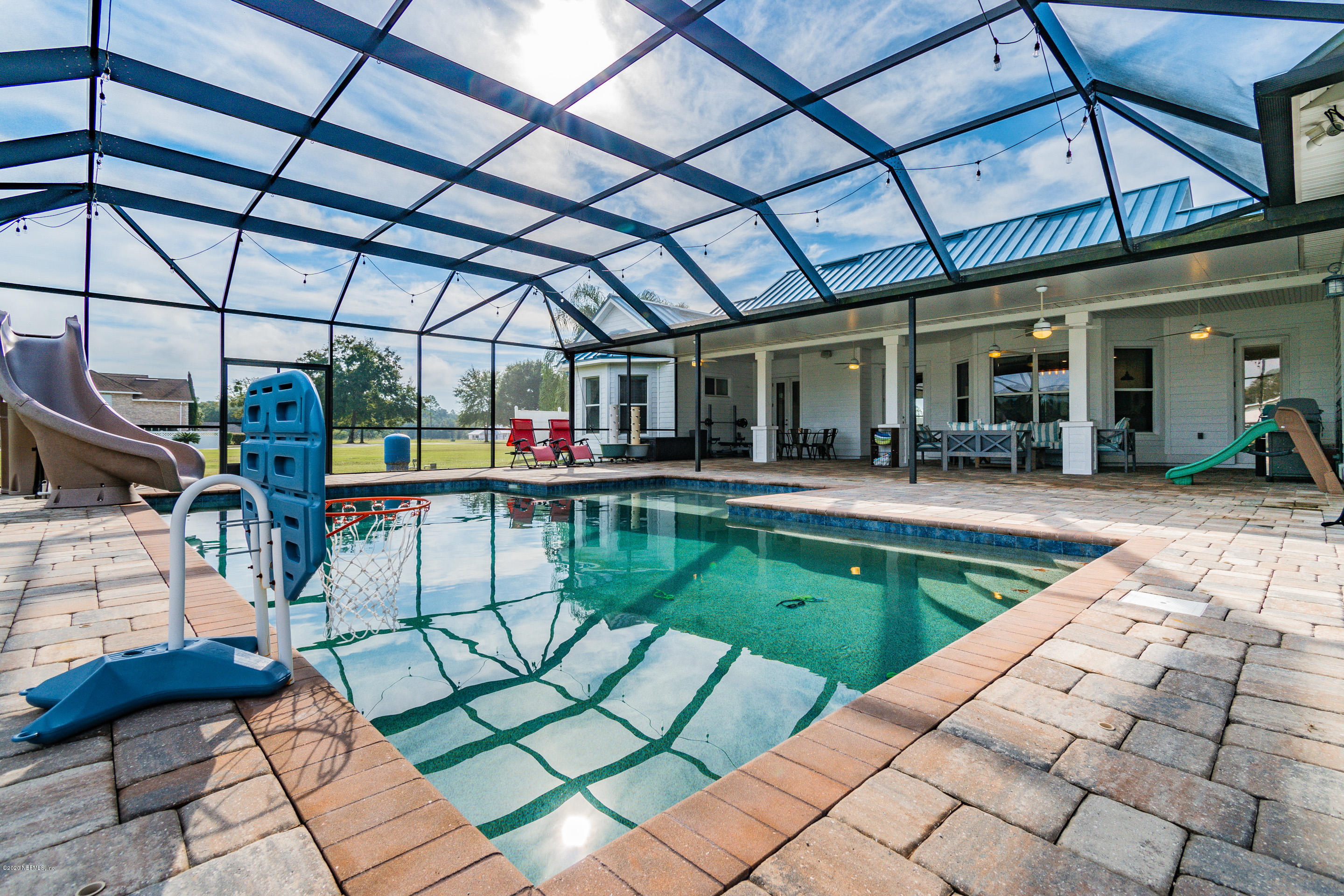 14689 Diamond Ranch Drive Jacksonville, FL 32234 - Photo 60 of 76 a view of a swimming pool with a patio