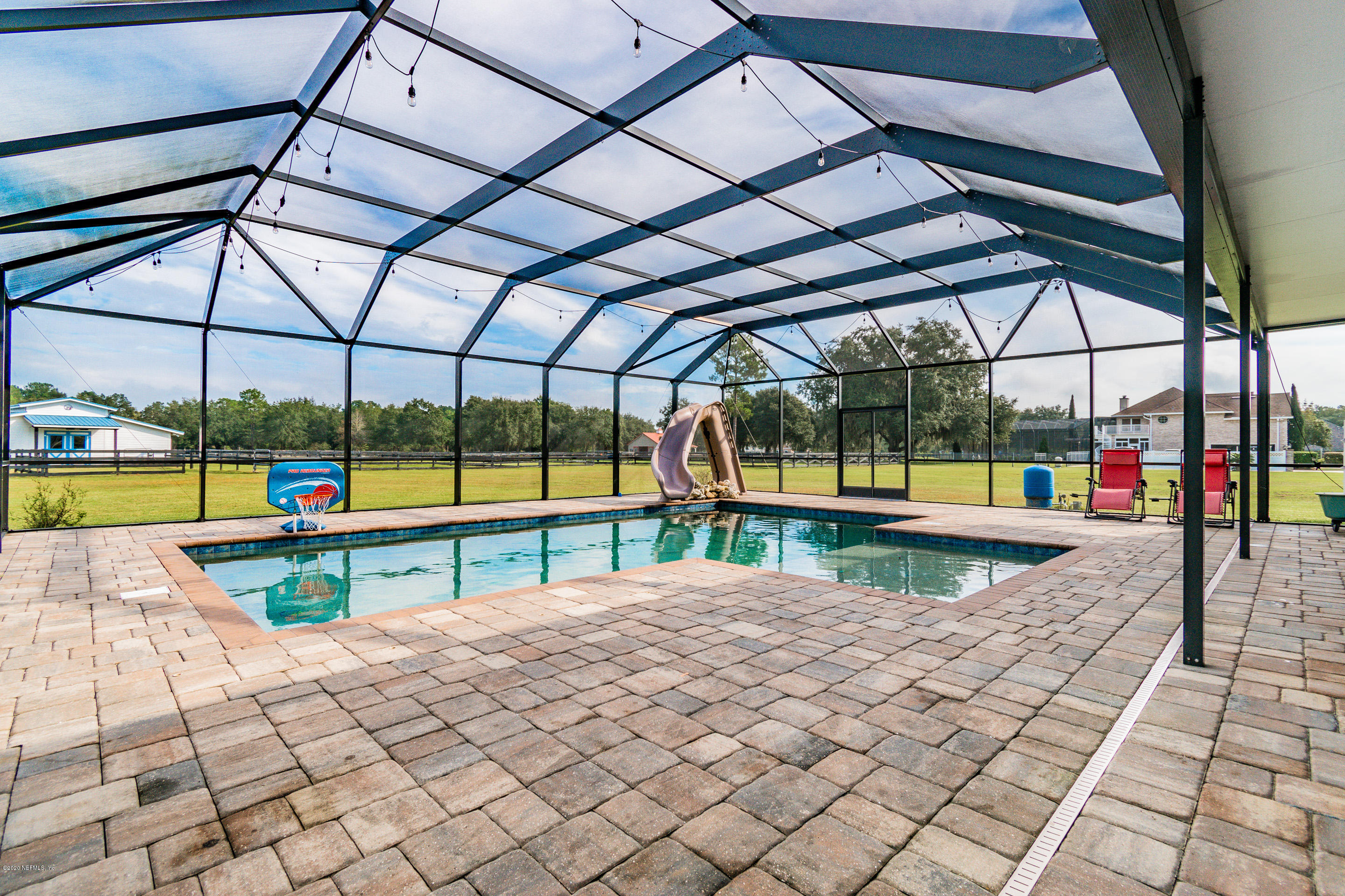 14689 Diamond Ranch Drive Jacksonville, FL 32234 - Photo 63 of 76 a view of a swimming pool with a couches and a table and chairs