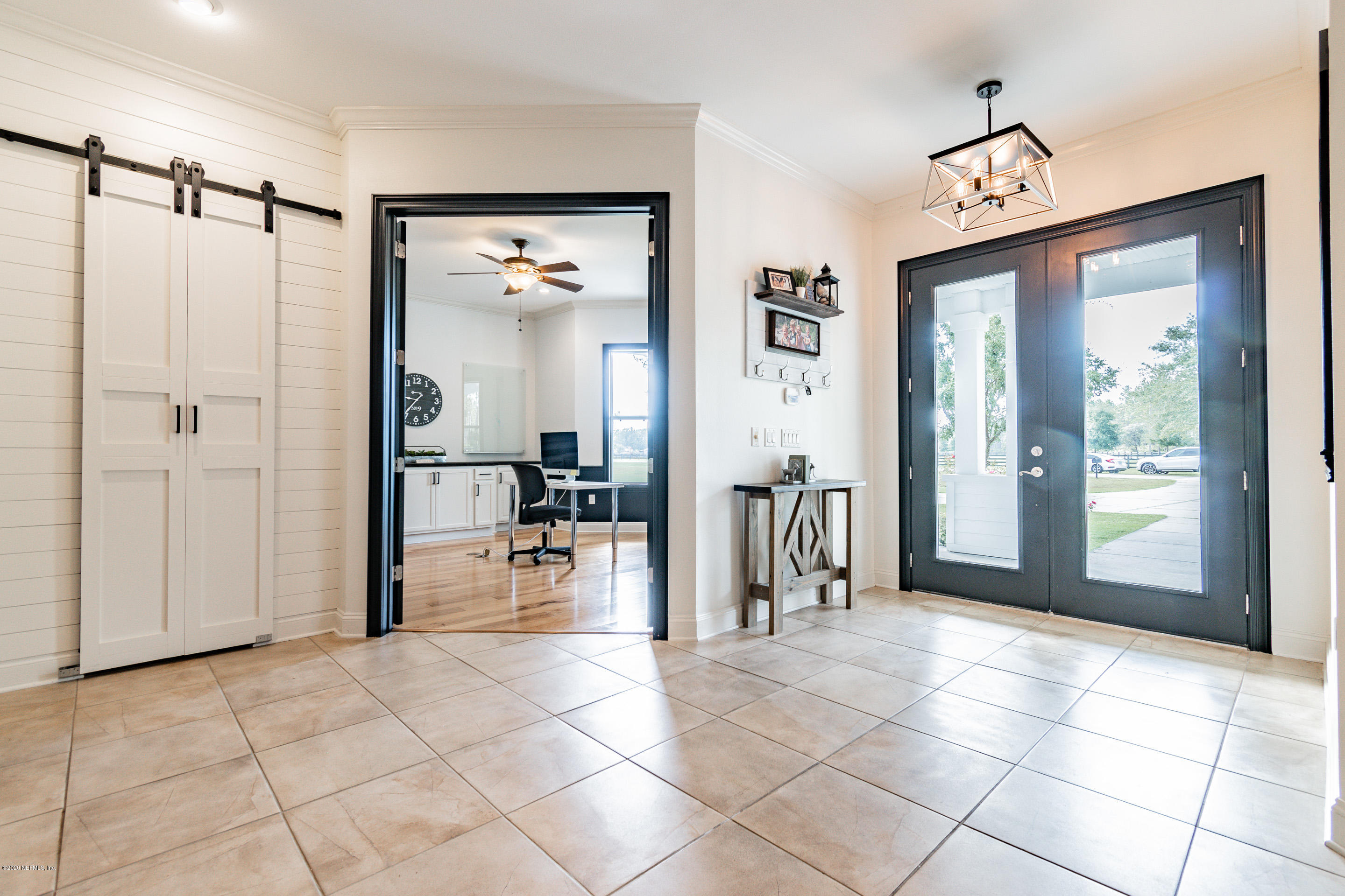 14689 Diamond Ranch Drive Jacksonville, FL 32234 - Photo 7 of 76 a view of a hallway with dining area and glass door