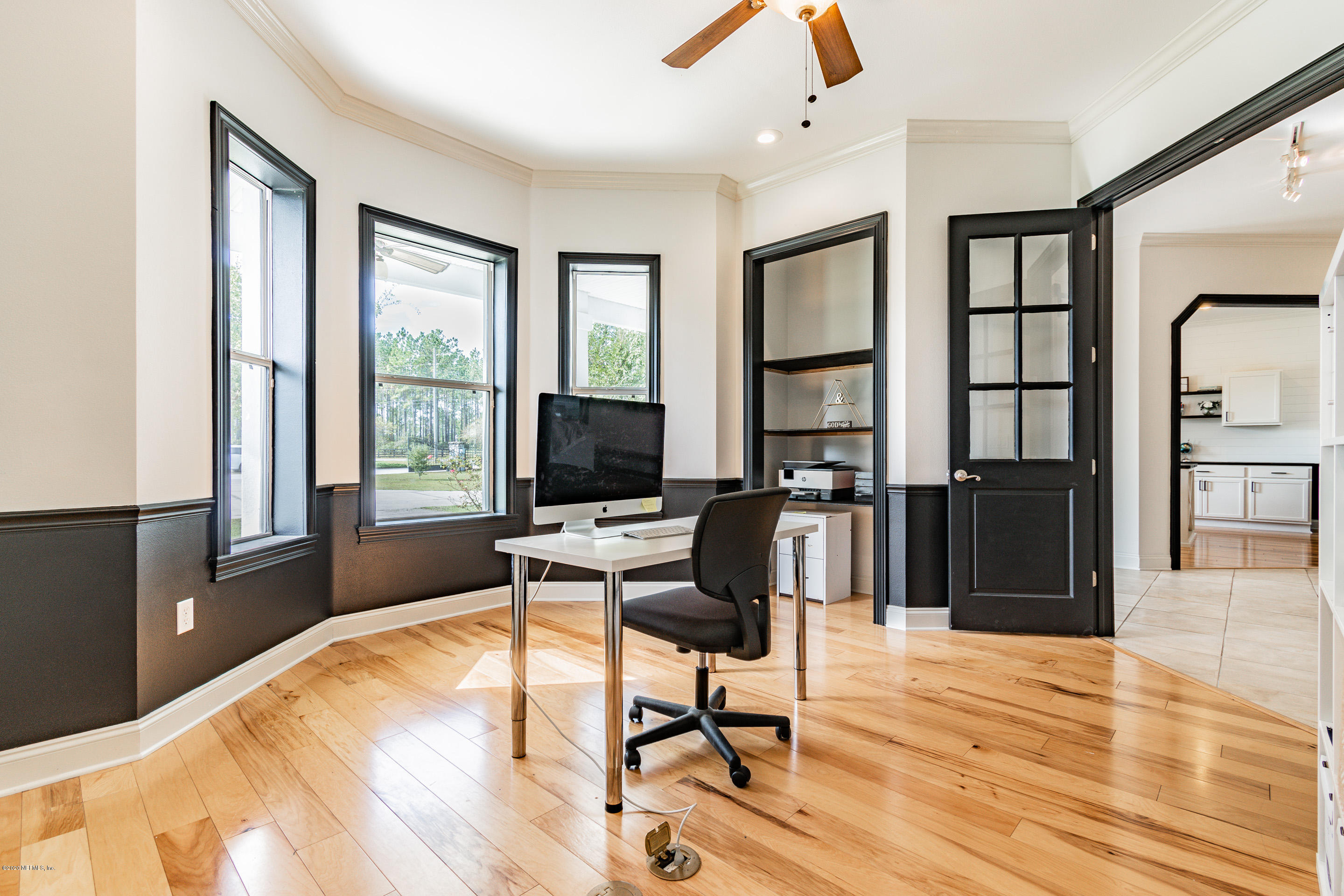 14689 Diamond Ranch Drive Jacksonville, FL 32234 - Photo 9 of 76 a workspace with wooden floor and a window