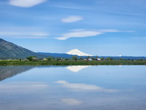 a outdoor view with swimming pool and mountain view