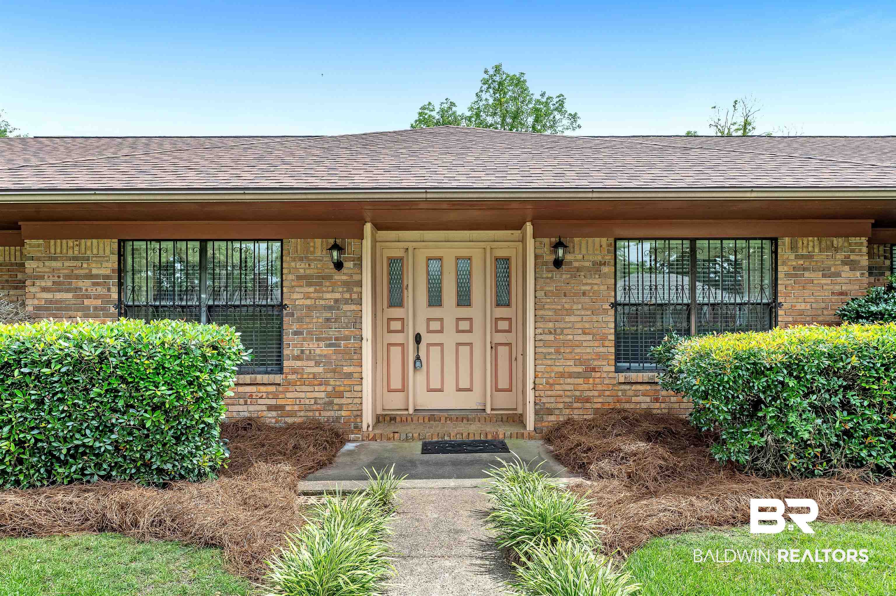 610 East Walker Avenue Foley, AL 36535 - Photo 4 of 38 Entrance to property featuring brick siding and roof with shingles